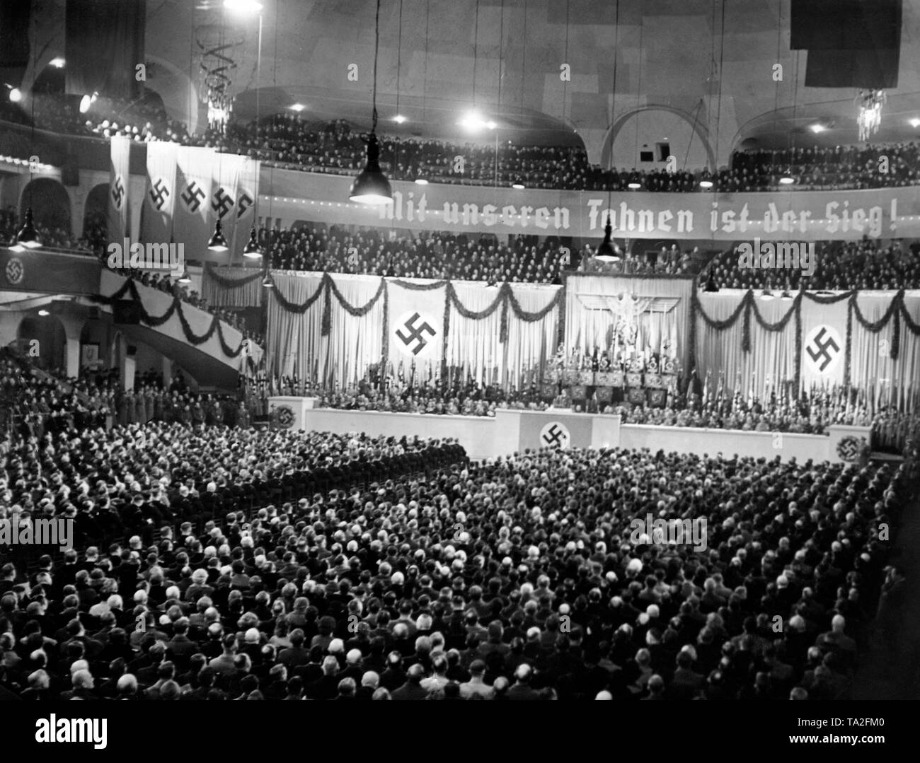 Adolf Hitler gives a speech at an NSDAP rally in the Berlin Sportpalast. On a banner: 'Victory is with our flags!' Photo: Schwahn Stock Photo