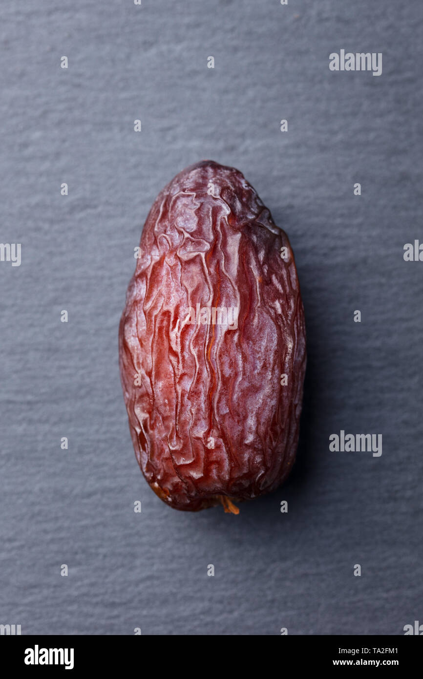 Fresh Medjool Dates. Grey slate background. Close up. Top view. Stock Photo