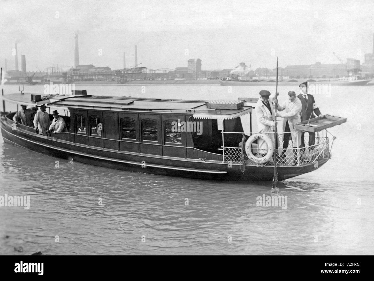 Water is taken from a boat in order to check the quality of the water. Stock Photo