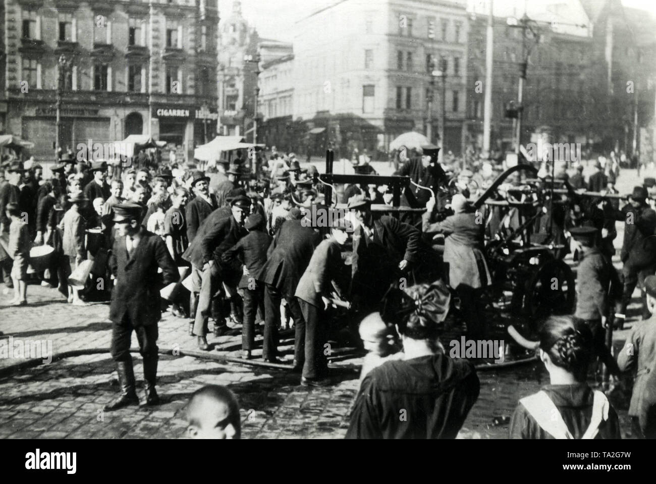 The uprisings in Upper Silesia also affected the population. Shortage of water was not a rarity, here several men distribute water to residents of Kattowitz by means of pumps of the fire brigade. Stock Photo