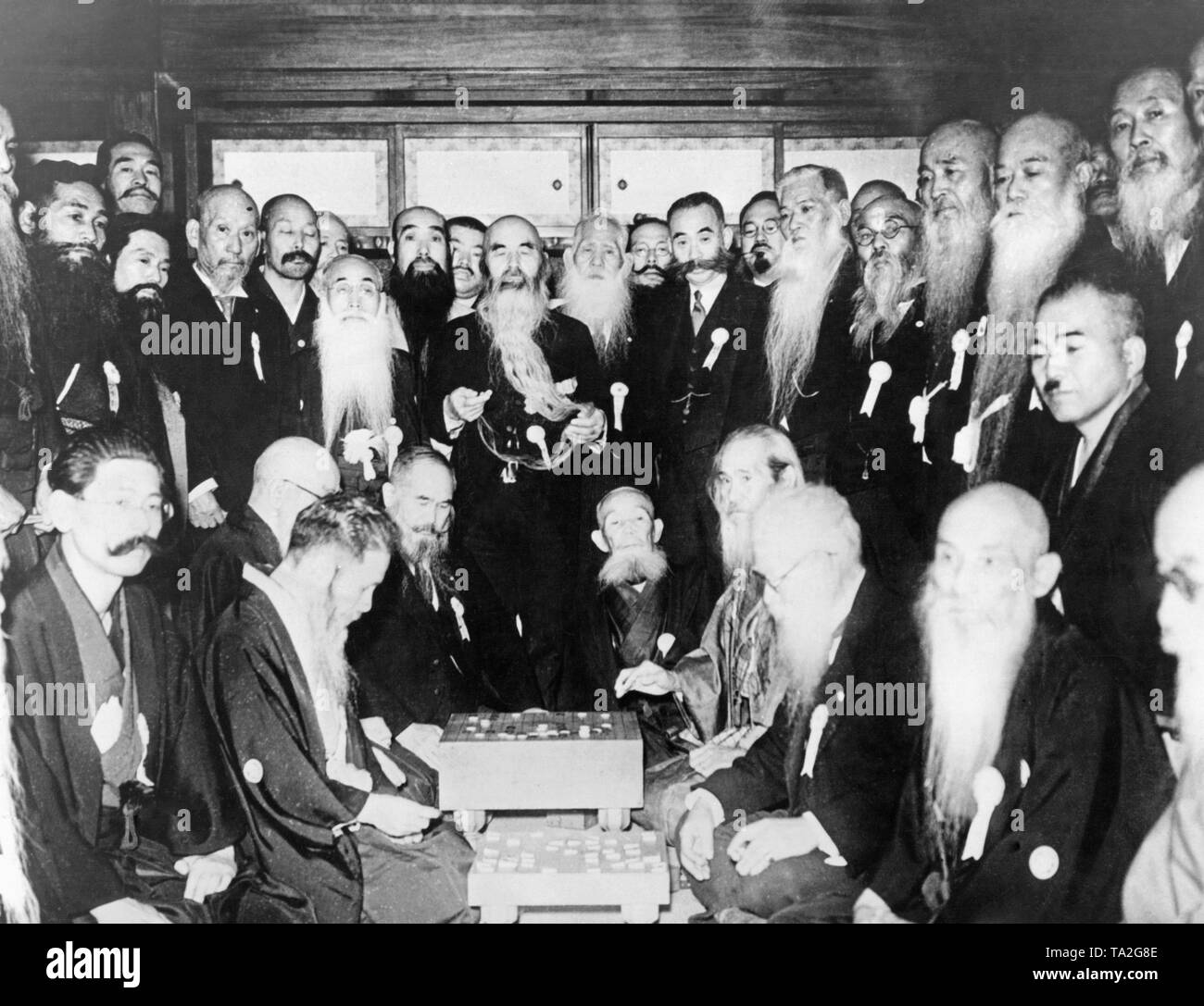 Members of the 'Bearded Club' in Japan at their bi-annual meeting in Tokyo on January 12, 1939. In the middle some of them are playing a board game. Stock Photo