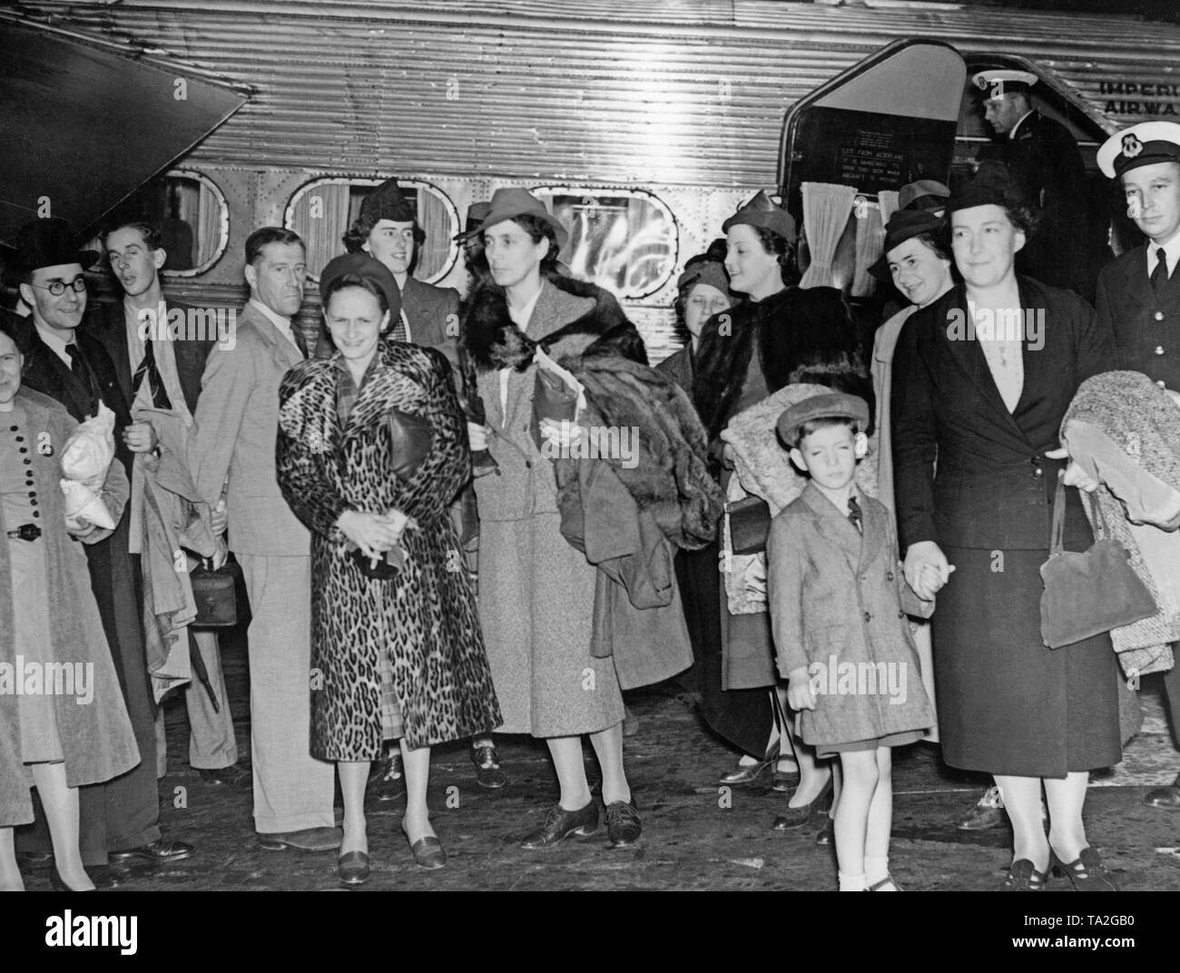 The British government evacuates British families from Prague. The families are flown out with an airplane of the Imperial Airways named 'Heracles'. According to the Munich Agreement in October 1938, Czechoslovakia had to cede the Sudeten German territories to the German Reich. Stock Photo