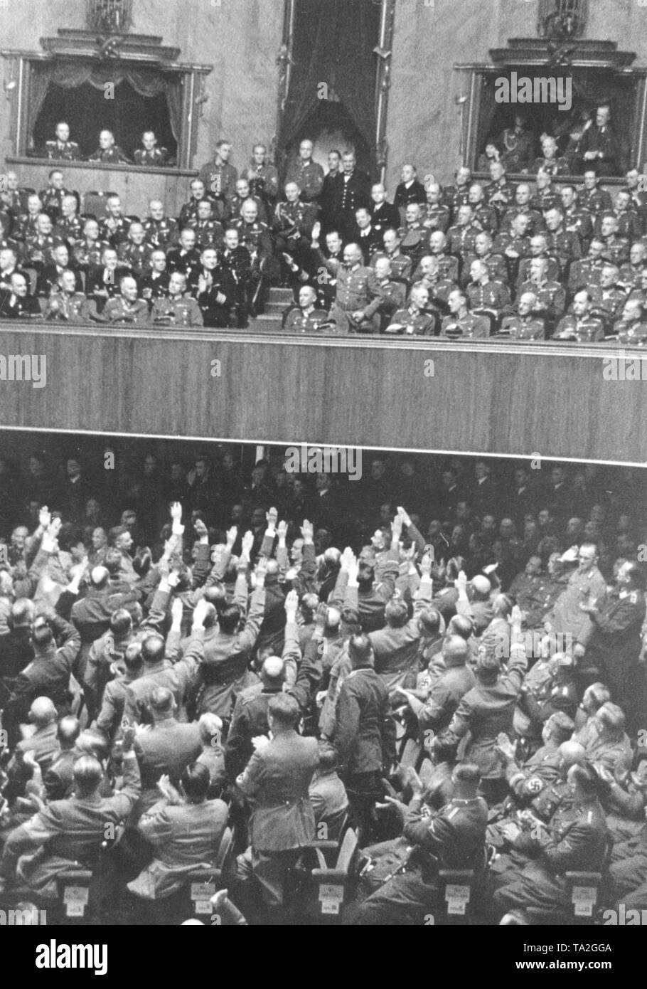 Spectators and deputies (bottom) of the Reichstag in the Kroll Opera House, the temporary seat of the Reichstag, at the honoring of the promoted Wehrmacht officers (see hands). Stock Photo