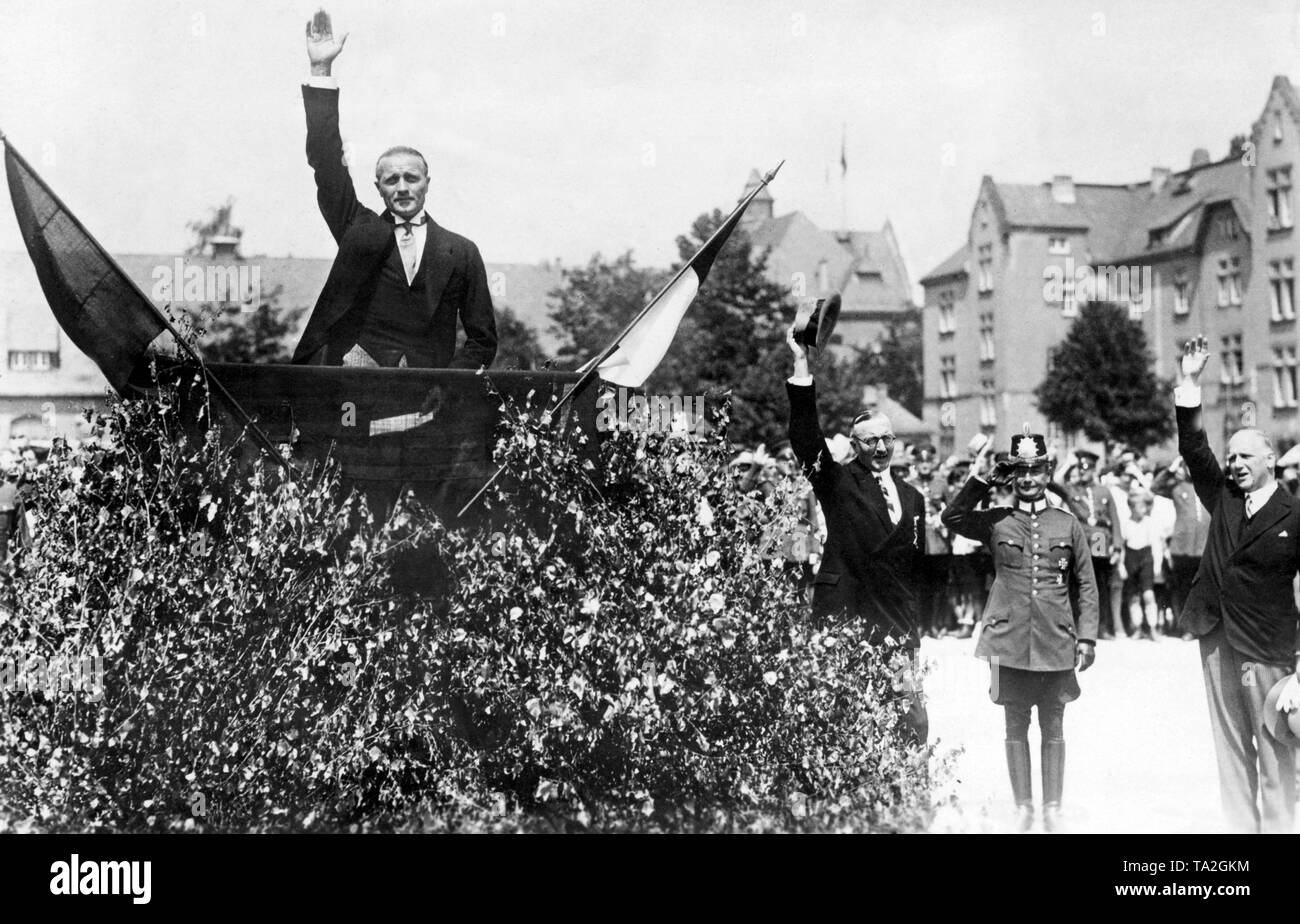 The well-known tennis player and police president of Wiesbaden was allowed to hold a speech at the ceremony of the Allied  evacuation of the Rhineland. He was transported in a carriage decorated with flowers and flags. Here he greets the crowd. Stock Photo