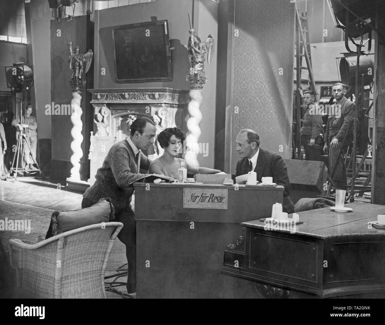 Gerhard Lamprecht, Tamara Tharsanina and dr. Eduard Rothauser at a production meeting in a Berlin film studio in the 20s. Stock Photo