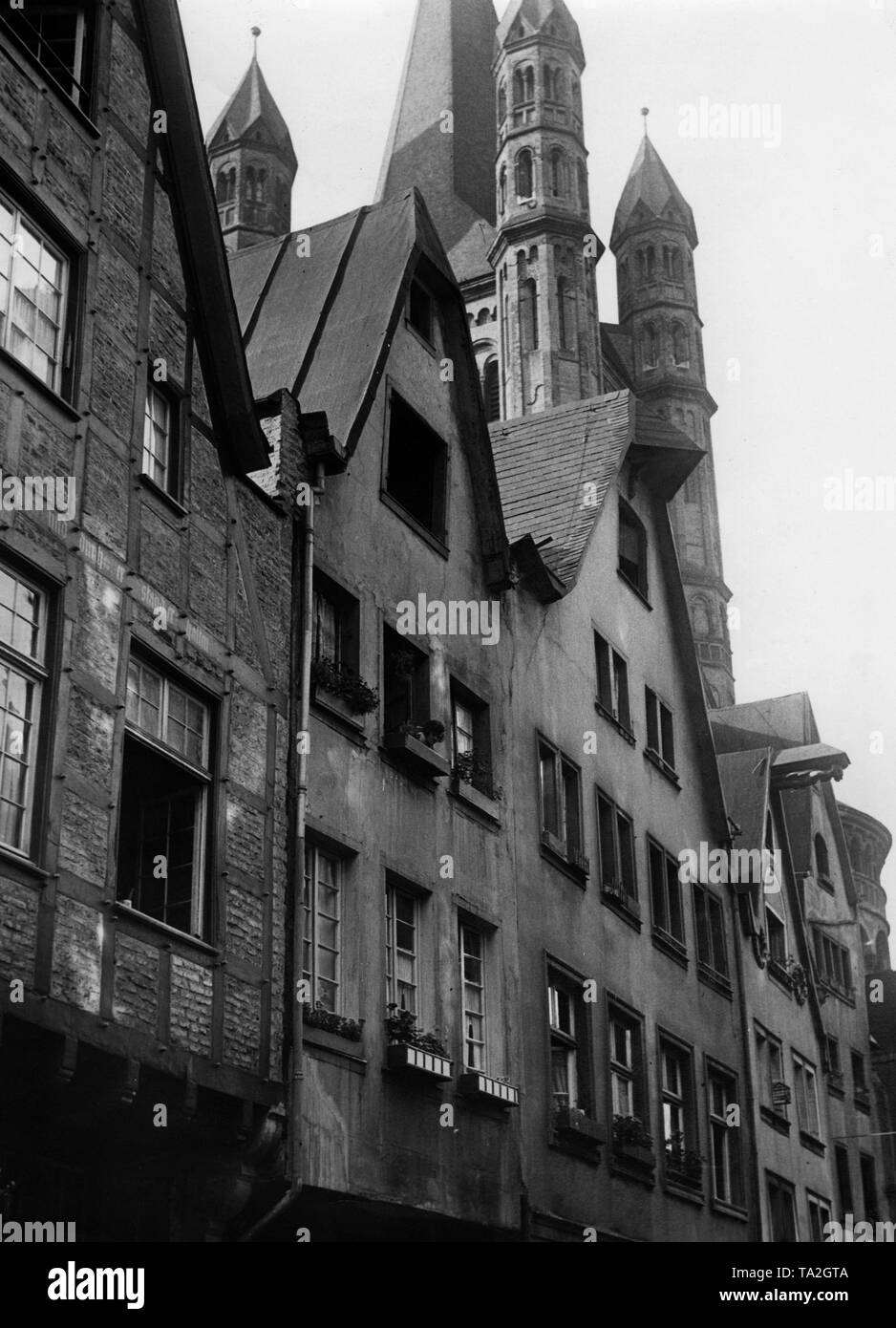 A row of houses in Cologne on the banks of the Rhine near the fish market. In the background, the Great St. Martin Church. Stock Photo