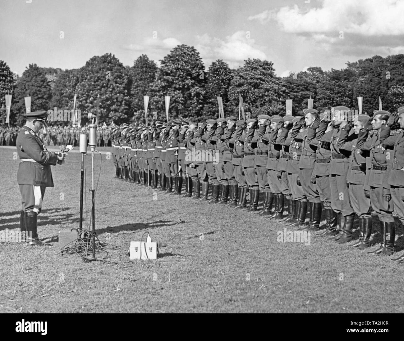 Photo of Field Marshal General Hermann Goering (chief commander of the Luftwaffe) at a speech delivered to pilot officers of the Condor Legion on the occasion of a victory parade in the Hamburg Moorweide at the Dammtor. The officers on the right are saluting. Stock Photo