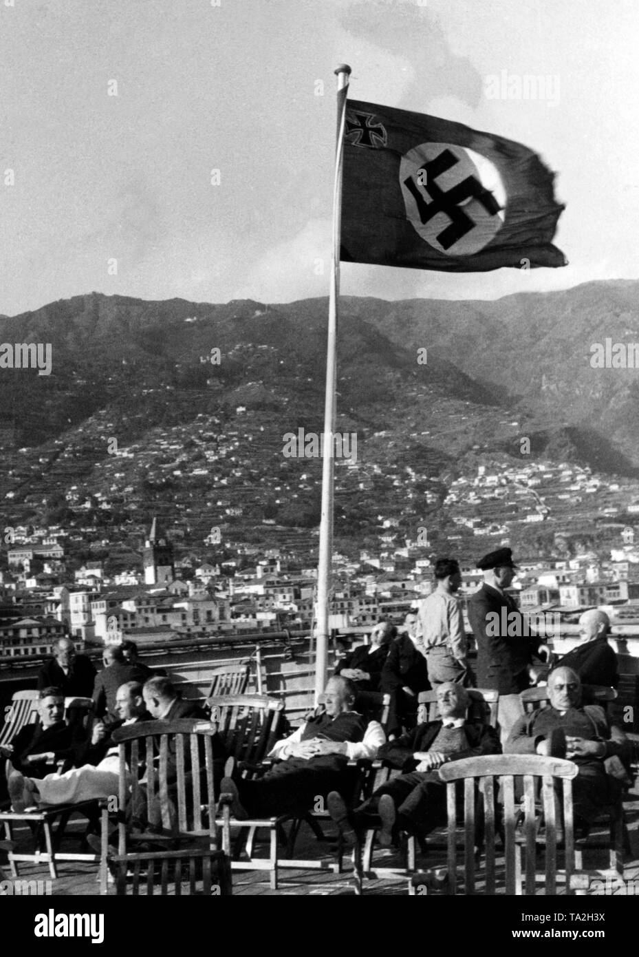 Vacationers of the Nazi organization 'Kraft durch Freude' ('Strength through Joy') are having a midday nap under a swastika flag in the port of Funchal in Madeira. Undated photo. Stock Photo