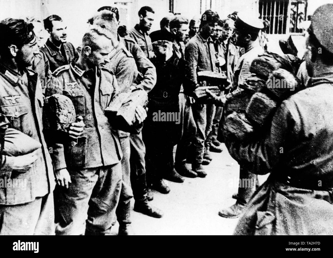 German soldiers, who were captured at Rostov, are given bread. Stock Photo