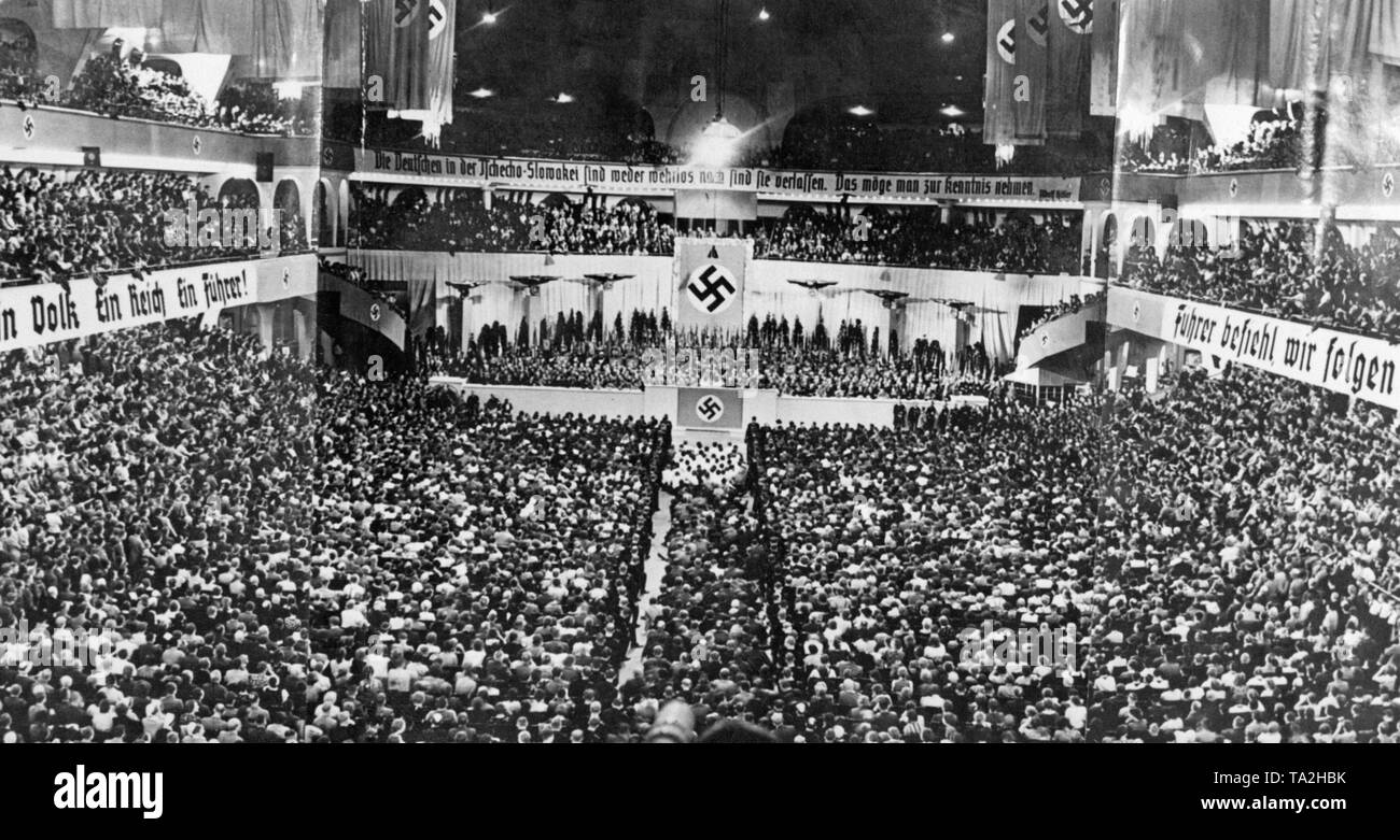 At the height of the Sudetenland crisis, Adolf Hitler gives a speech at the Berlin Sportpalast. He mentioned the cession of the Sudetenland to the German Reich as his last demand for territorial revision. On the posters on the side: 'One People, One Reich, One Fuehrer' and 'Fuehrer, give Your command and we follow'. Above the stage: 'The Germans in Czechoslovakia are neither defenseless nor abandoned. That should be acknowledged. ' Stock Photo