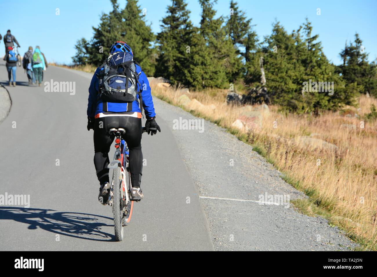 a cyclist on the way to the summit of Brocken in the Harz National Park Stock Photo