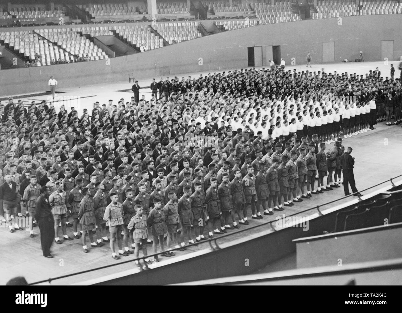 A group of Italian teenagers on a visit to the German Reich. Here they holds a rehearsal in the Deutschlandhalle. Stock Photo
