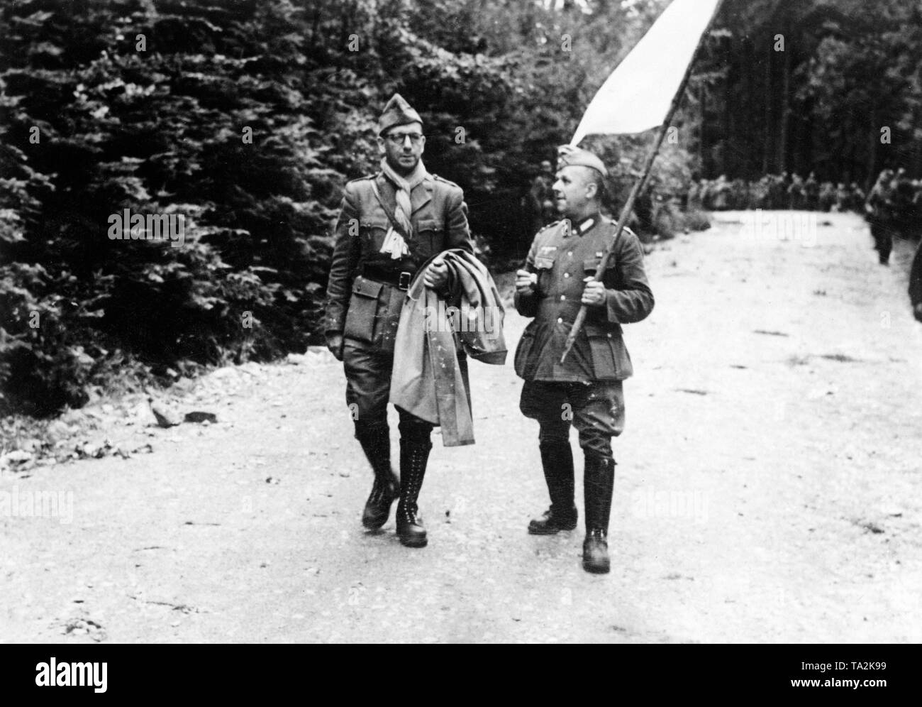 A French parliamentarian is accompanied by a German Wehrmacht official to a German unit. Photo: Maes Stock Photo