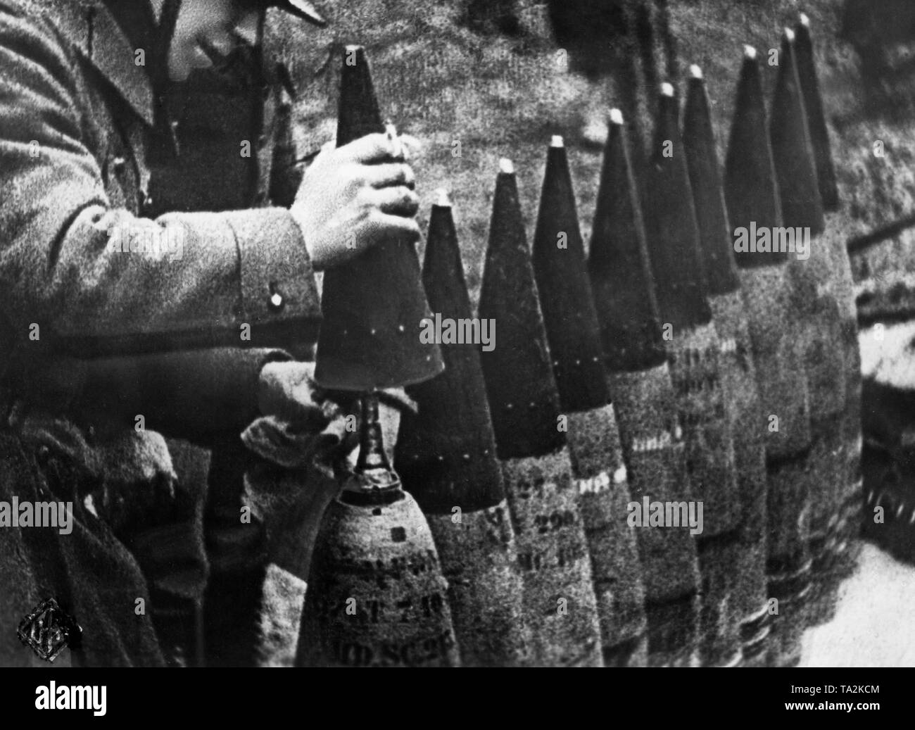 A German gunner mounts the fuze of explosive grenades. Picture from the military film Sieg im Westen (Victory in the West). Stock Photo