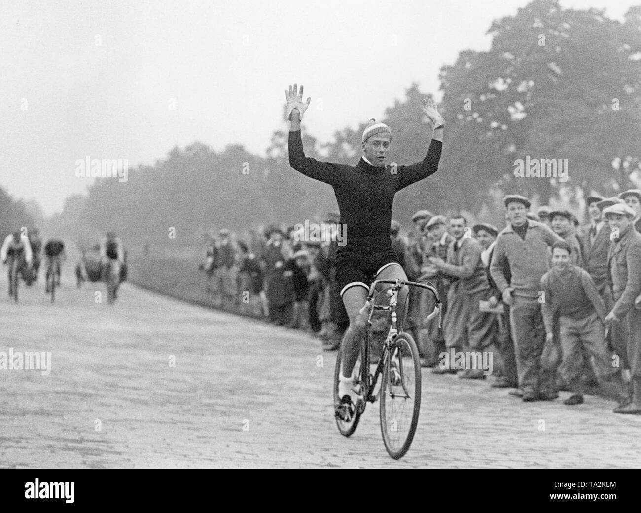 The winner of the cycle race for sports journalists rides through the finish. Stock Photo