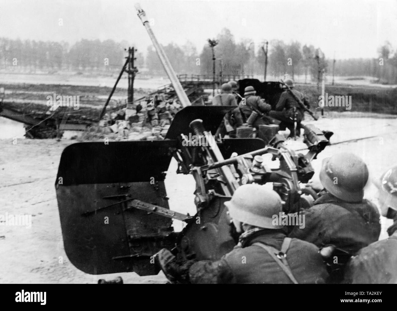 A light 2-cm-Flak 38 secures the attack points of the infantry. In the background a 3rd7 cm-PaK 36 of the Wehrmacht. Stock Photo