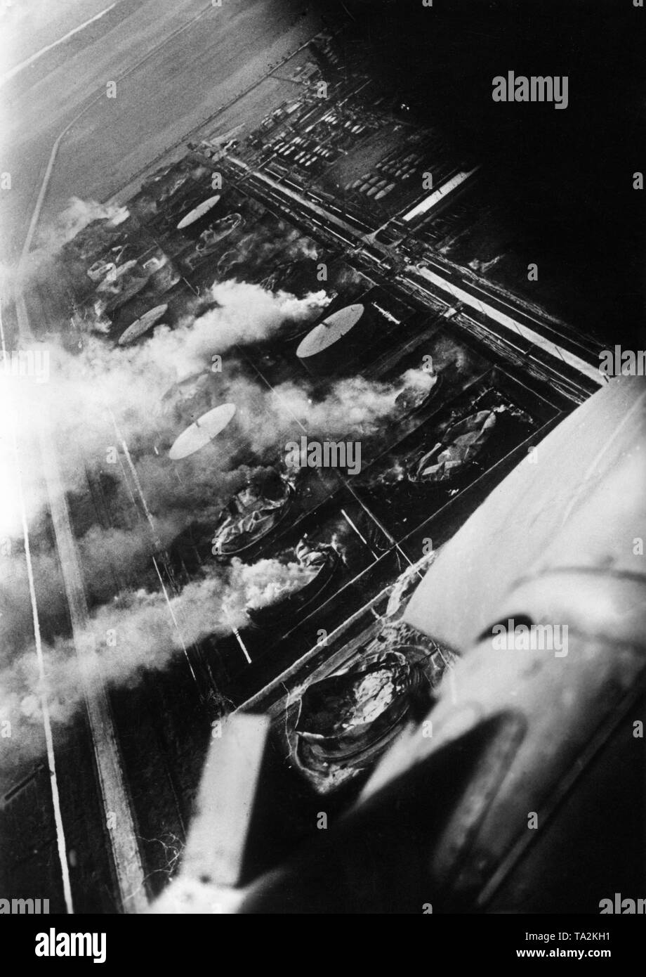 A Kampfgeschwader of Stukas (probably Junkers Ju 88 dive bombers) in an attack on the French city of Le Havre. Here, burning oil tanks of the harbor facility. Photo: war correspondent Stift. Stock Photo