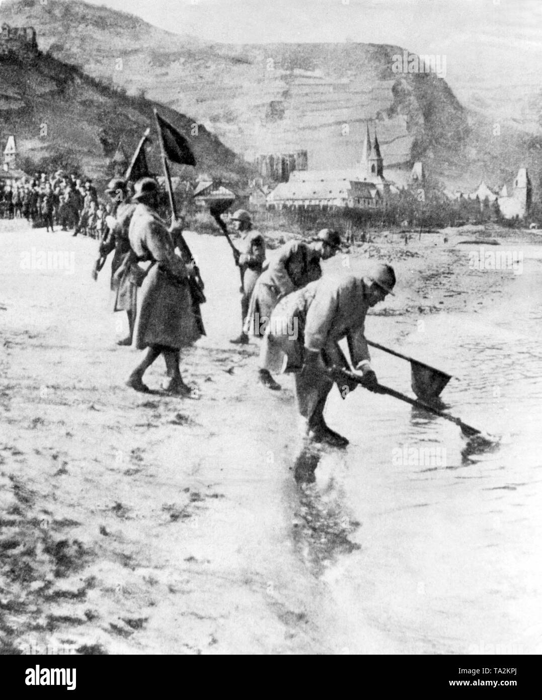 Shortly before their withdrawal from the Rhineland, these French soldiers submerged their flags and regimental pennants into the waters of the Rhine to symbolically document their claim to the river. Stock Photo