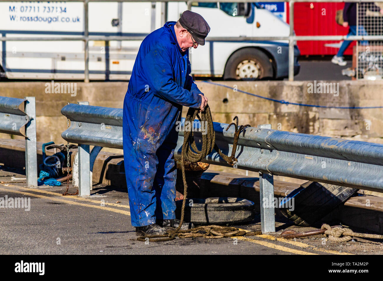 A man working on the quayside of Seahouses and North Sunderland harbour, Northumberland, UK. October 2018. Stock Photo