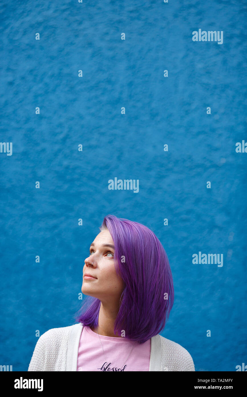Beautiful Bright Girl With Purple Hair On A Blue Background