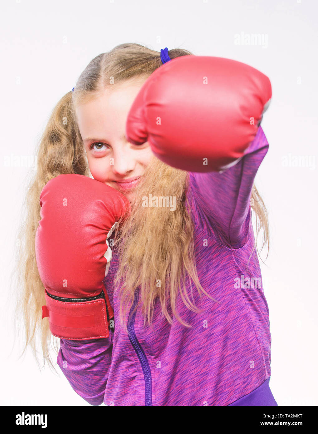 little girl in boxing gloves punching. Sport and sportswear fashion