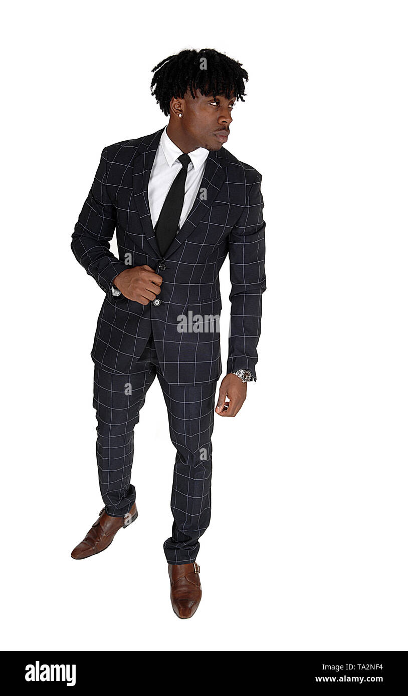 An African American young man standing in a suit and white shirt and ...