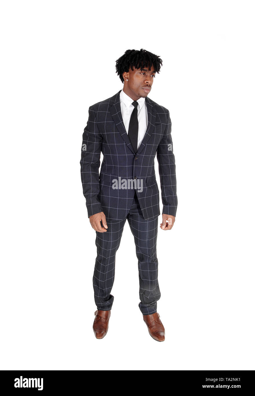 An young African American man in a dark gray suit and tie standing in ...