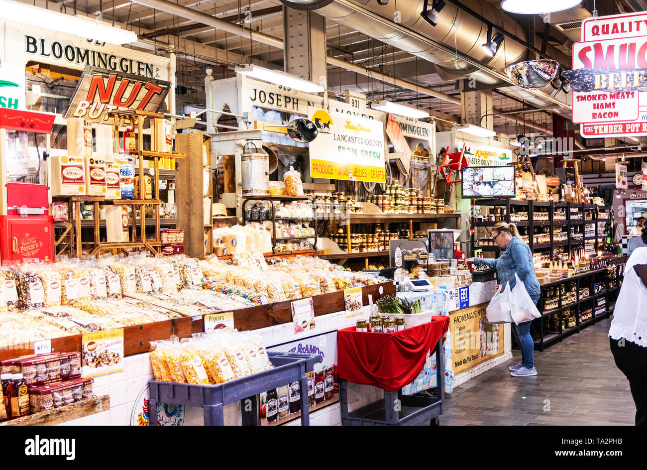 Philadelphia, Pennsylvania, USA - 26 April 2019: The inside of Reading Market with people shopping locally grown goods and popcorn. Stock Photo