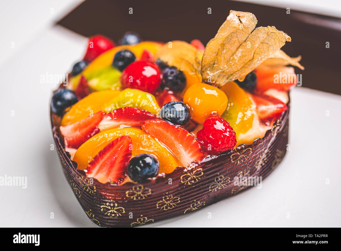 Heart shaped fruit sponge cake, Fruit Tart on a square plate on table.  Healthy confectionery background. space for text Stock Photo - Alamy