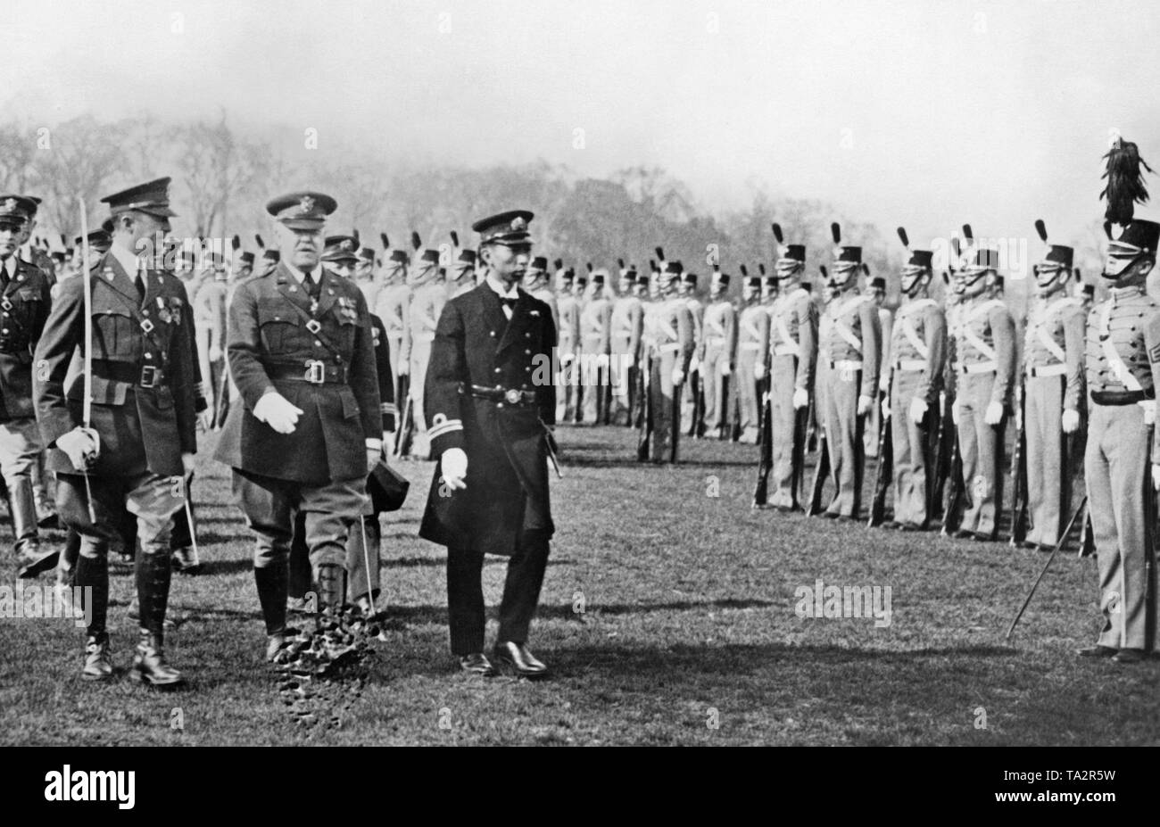 The brother of the Japanese Emperor Hirohito, Prince Takamatsu (right) takes the salute of the American cadet school in West Point. Stock Photo