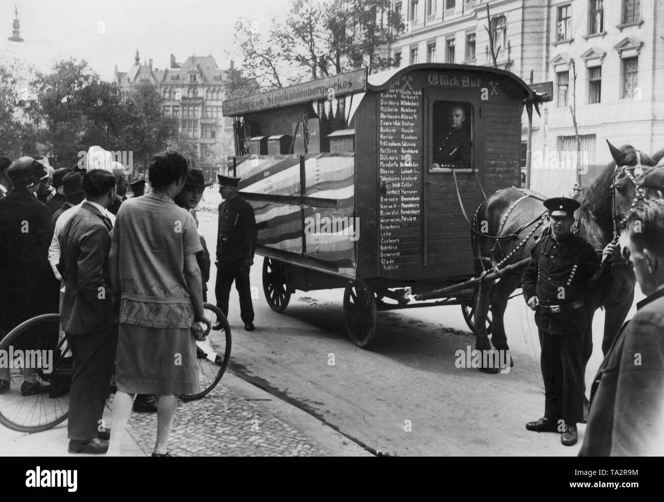Three unemployed miners travel through Germany with a trailer. The self-painted horse cart shows a coal mine. As here in Berlin they give lectures on the streets or in schools to promote the miners' association. Stock Photo