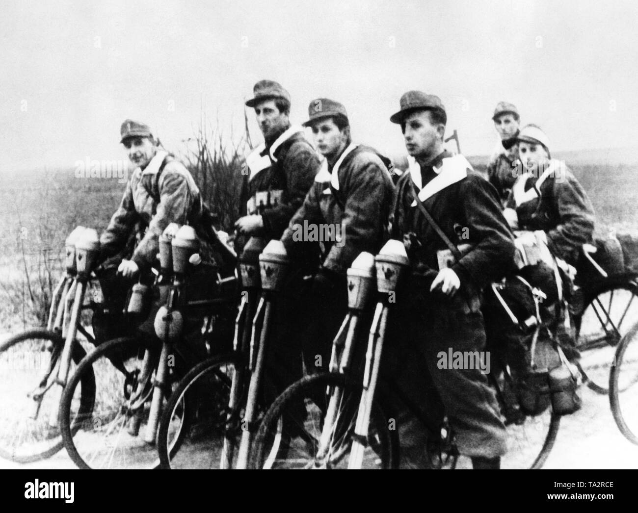 Members of the Wehrmacht on bicycles with anti-tank rocket launchers, deployed as 'flying fighter command' against Russian tanks in Breslau. Stock Photo
