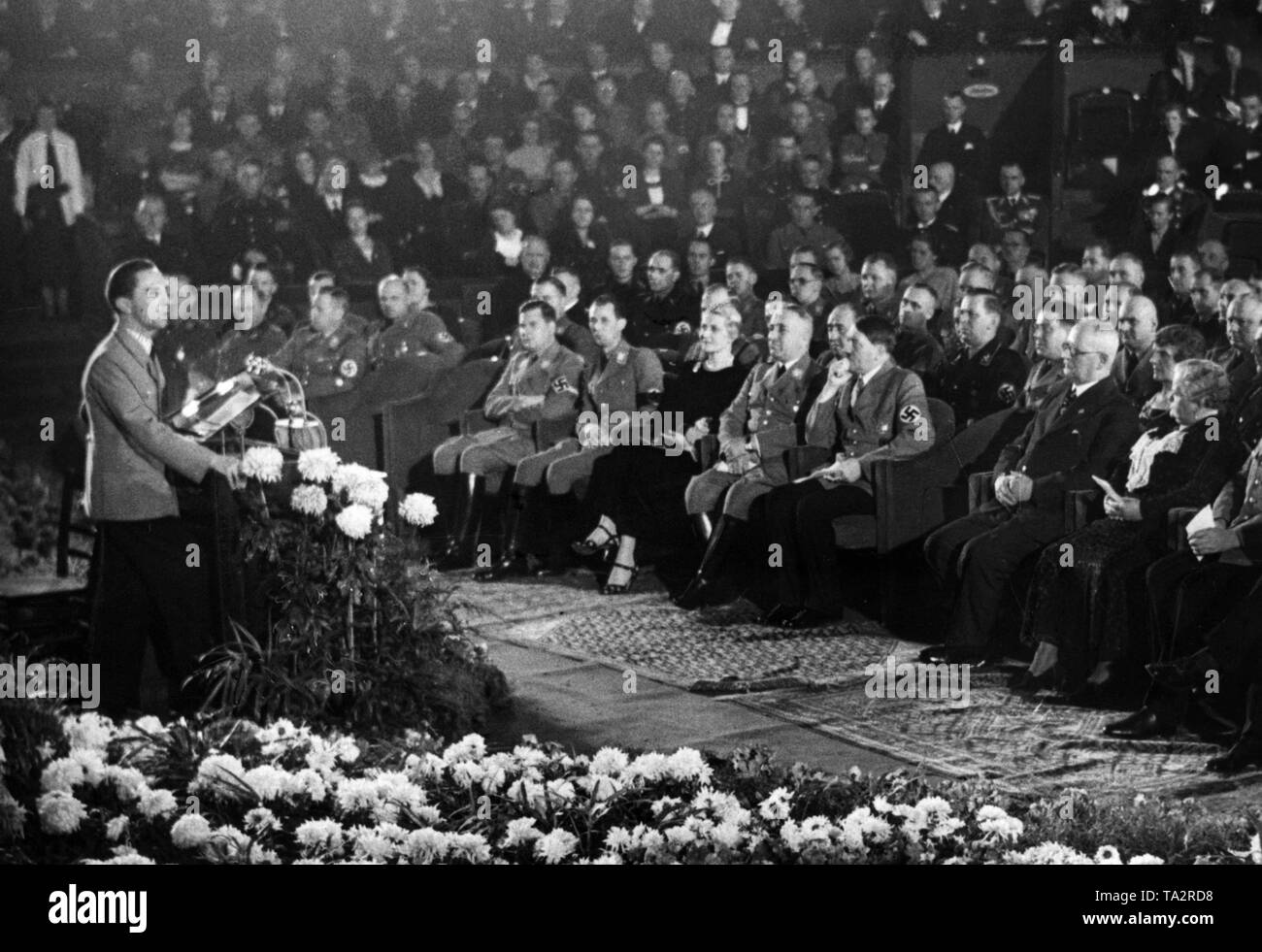 A festive evening takes place on the occasion of the second anniversary of the founding of the Nazi organization 'Kraft durch Freude' at the 'Theater des Volkes' (Theater of the People) in Berlin. Joseph Goebbels is holding a speech. Sitting from left: Baldur von Schirach, undersecretary Horst Dressler-Andress, Magda Goebbels, Robert Ley, Adolf Hitler (behind him, chief advisor Julius Schaub), Franz Xaver Schwarz and Berta Schwarz. Stock Photo