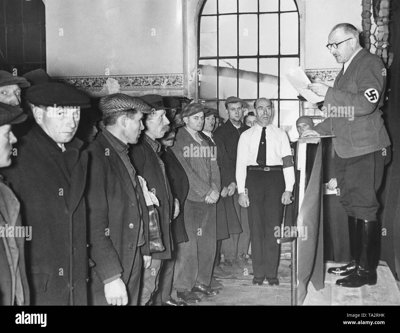 Before the upcoming Sudeten German by-elections, there is a company roll-call in the pit 'Richard'. The chairman of the company reminds employees of the importance of the elections. In the plebiscite, votes are cast concerning the annexation of the Sudetenland to the German Reich. Stock Photo