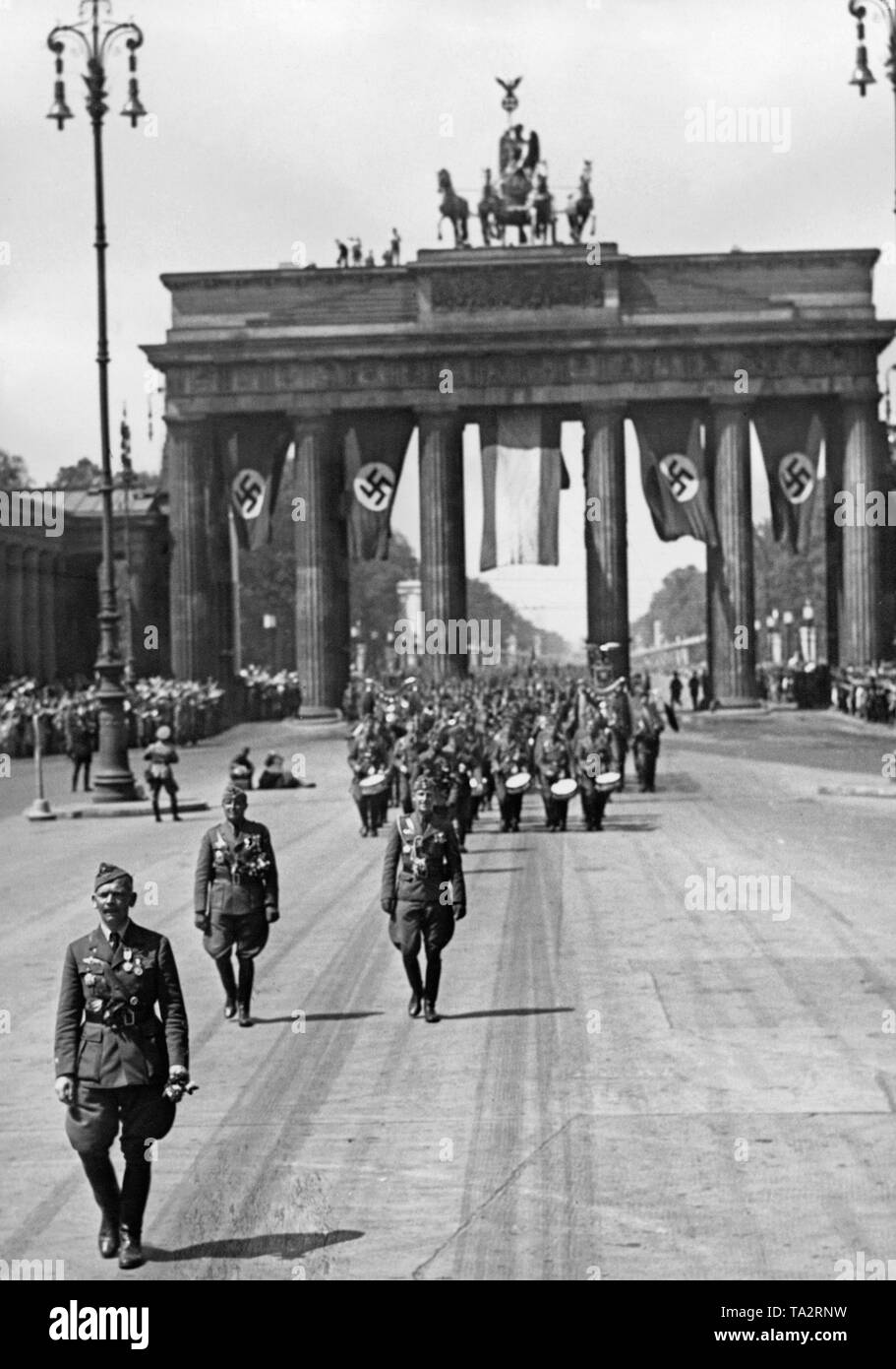 Photo of Major General Wolfram Freiherr von Richthofen (front left) at the forefront of his troop during their march across the Pariser Platz (Unter den Linden) to the East towards Lustgarten on the occasion of the parade on the return of the Condor Legion from Spain on the 6th of June, 1939. In the background, the Brandenburg Gate with swastika flags and the Spanish Bandera. On the horizon the East-West Axis (former Charlottenburger Chaussee). Stock Photo
