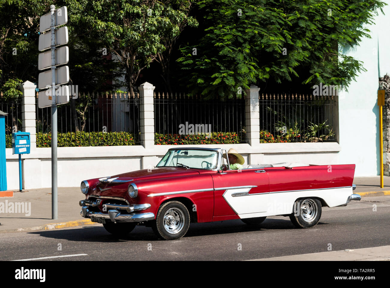 Havana, Cuba - 25 July 2018: A red and white classic Chevy convertible being used as a taxi on the streets of Havana Cuba. Stock Photo