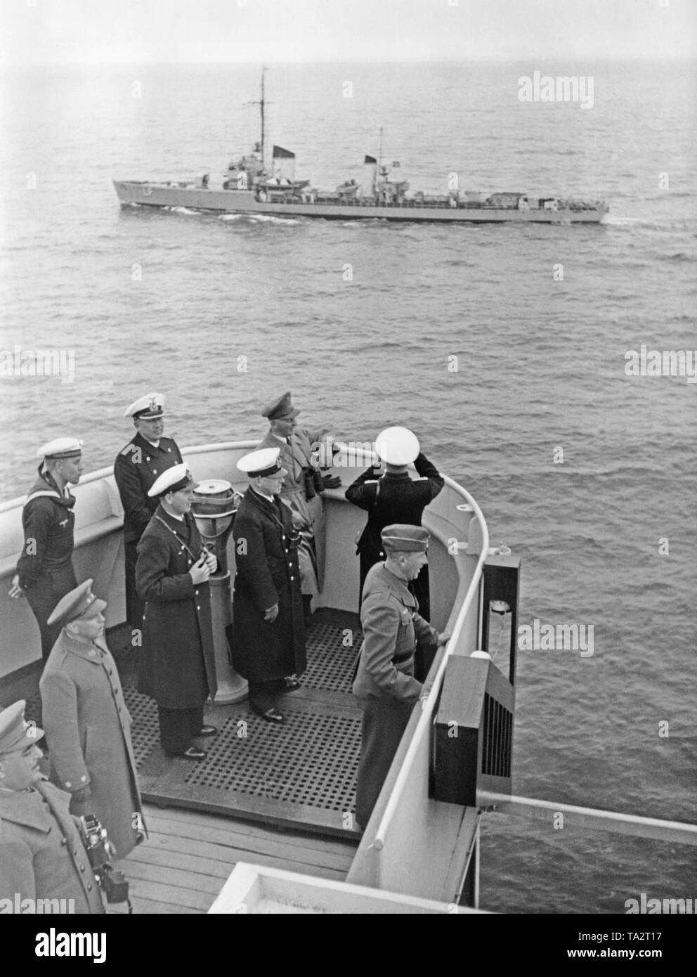 Photo of the bridge of the German cruise ship 'Robert Ley' (flagship of the KdF fleet) in the North Sea off Borkum. German naval officers and Spanish guests, including General Antonio Aranda Mata (far left below), are received by a German squadron. On board, the returned German soldiers, who had fought with the Condor Legion on the side of Franco's troops. Stock Photo