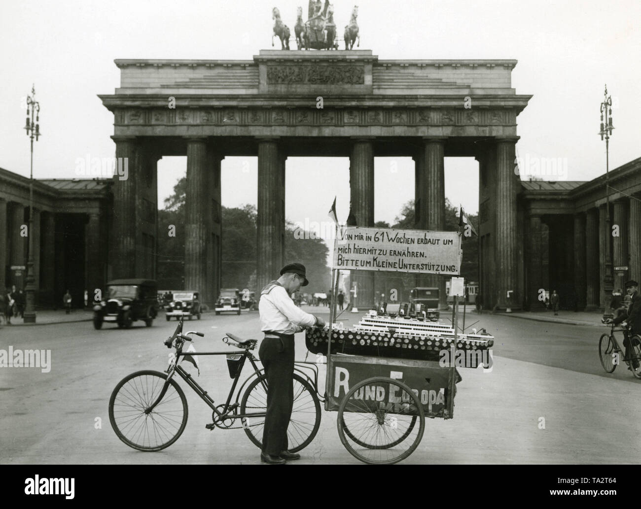 An unemployed sailor makes a stop in Berlin-Mitte during his European tour with his model of the passenger ship 'Imperator' . With the ship he appeals for a small support. With such models, people tried to increase people's willingness to donate and earn their living. Stock Photo