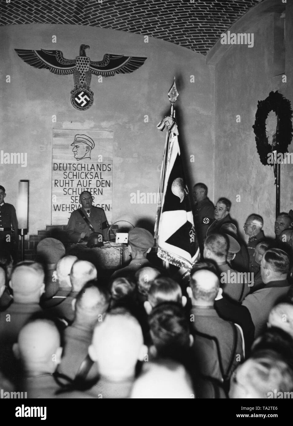 The leader of the National Socialist Alliance of Red Front-Fighters (Stahlhelm), Franz Seldte, holds an inauguration speech in Frankfurt (Oder) in front of members of the Landesgruppe Ostmark on the newly built  'Morozowicz-Gedenkhalle' ('Morozowicz Memorial Hall') in memory of the deceased leader of the Stahlhelm in Brandenburg, Elhard von Morozowicz . Under the drawing is the slogan: 'Germany's fate rests on the shoulders of its defensive youth!' Stock Photo