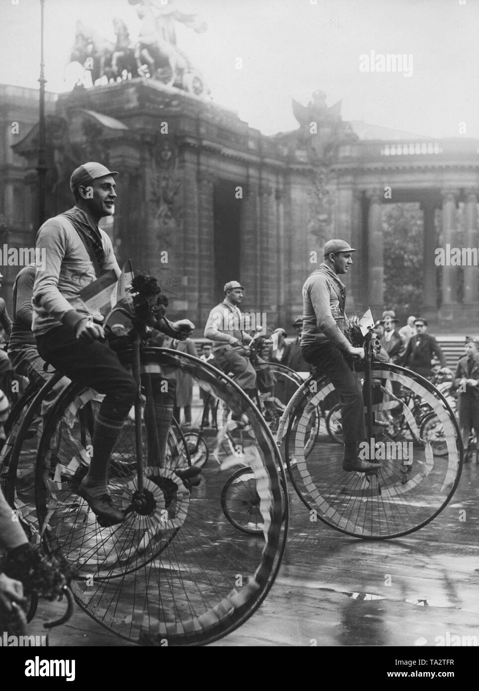 Men on high wheels as part of the pageant on Cycling Day in Berlin. Stock Photo