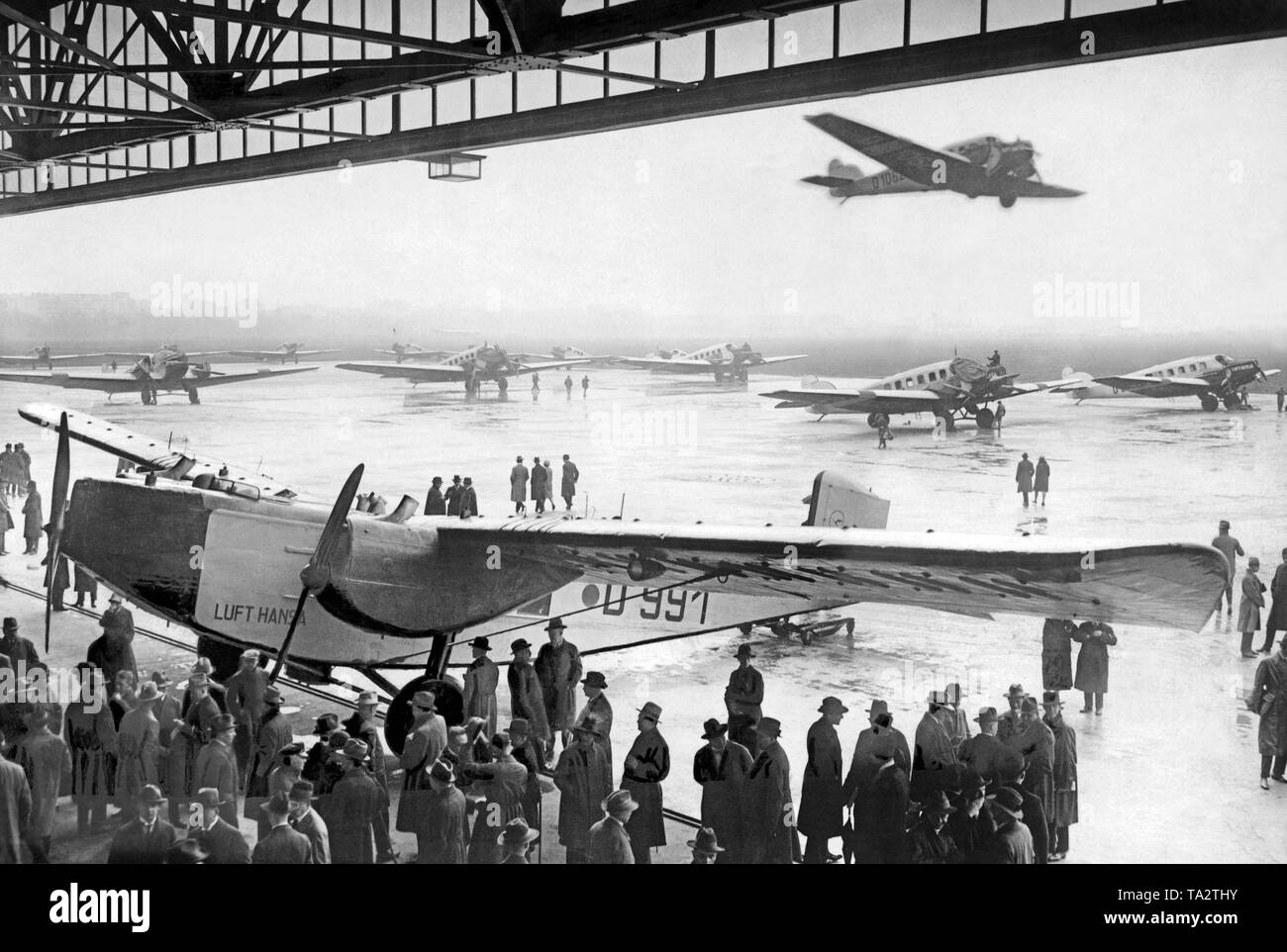 Opening of the summer air traffic of the Deutsche Lufthansa. On the maneuvering area of Tempelhof Airport there are various Junkers aircrafts, in the hangar a Rohrbach Ro VIII 'Roland'. Stock Photo