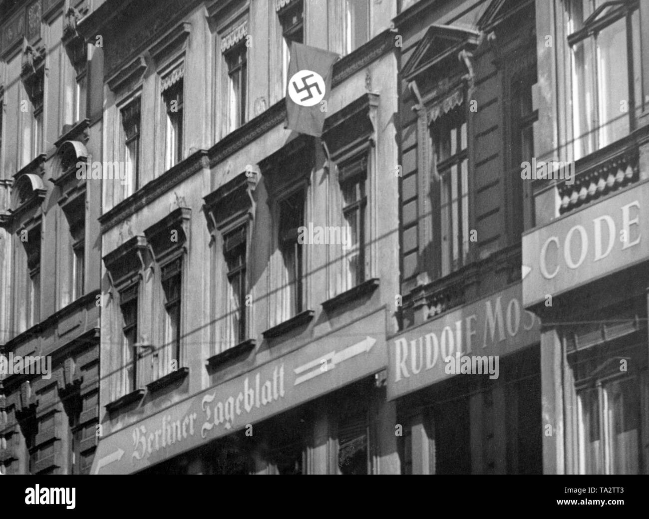 A swastika flag is waving on the house of the Berliner Tageblatt in the Zimmerstrasse, Berlin. The newspaper belonged to a Jewish publishing group. Stock Photo