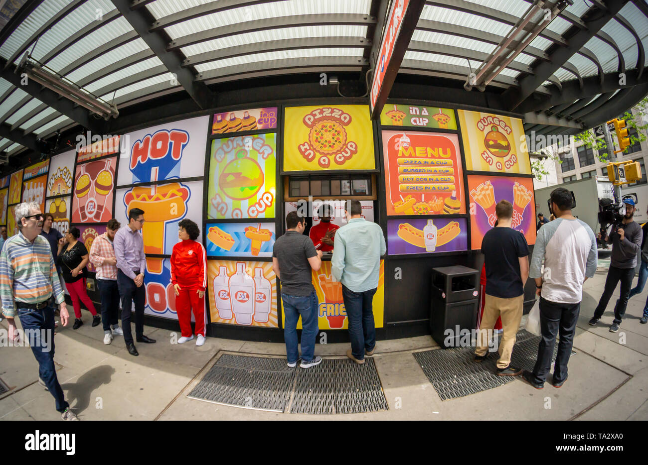 Participants line up to to be filmed trying samples of products from the fictional company â€œBuy n Largeâ€, in Midtown Manhattan in New York on Wednesday, May 8, 2019. â€œBuy n Largeâ€ is a fictional company used in several of Pixar films including â€œWALL-Eâ€.  (Â© Richard B. Levine) Stock Photo