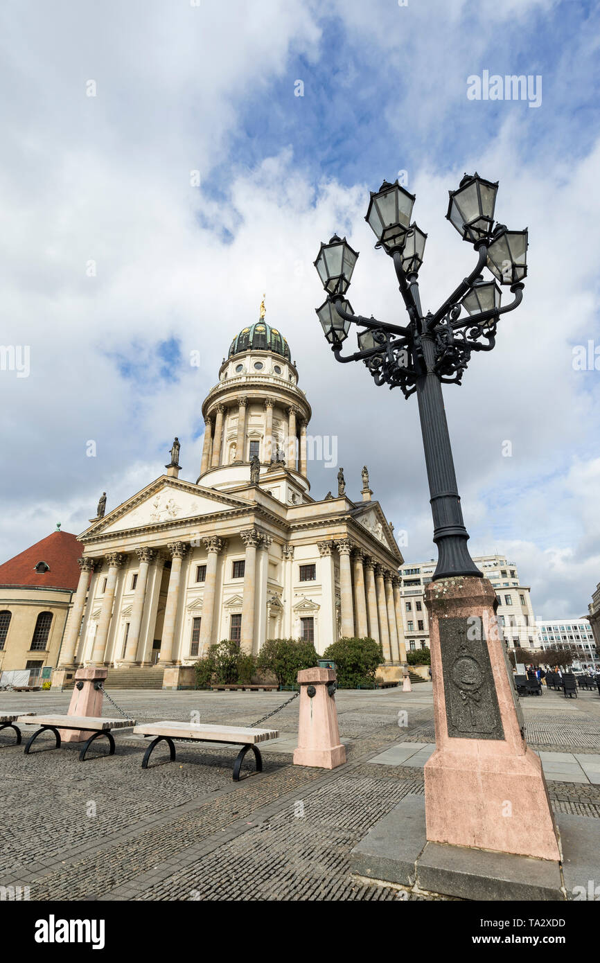 Old streetlight and Französischer Dom (French Cathedral) at the Gendarmenmarkt Square in Berlin, Germany, at day. Stock Photo