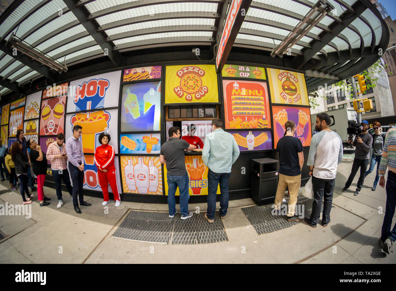 Participants line up to to be filmed trying samples of products from the fictional company â€œBuy n Largeâ€, in Midtown Manhattan in New York on Wednesday, May 8, 2019. â€œBuy n Largeâ€ is a fictional company used in several of Pixar films including â€œWALL-Eâ€.  (Â© Richard B. Levine) Stock Photo