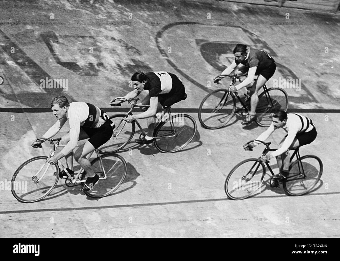 Four track cyclists ride close together at the Olympiabahn in Berlin. Stock Photo