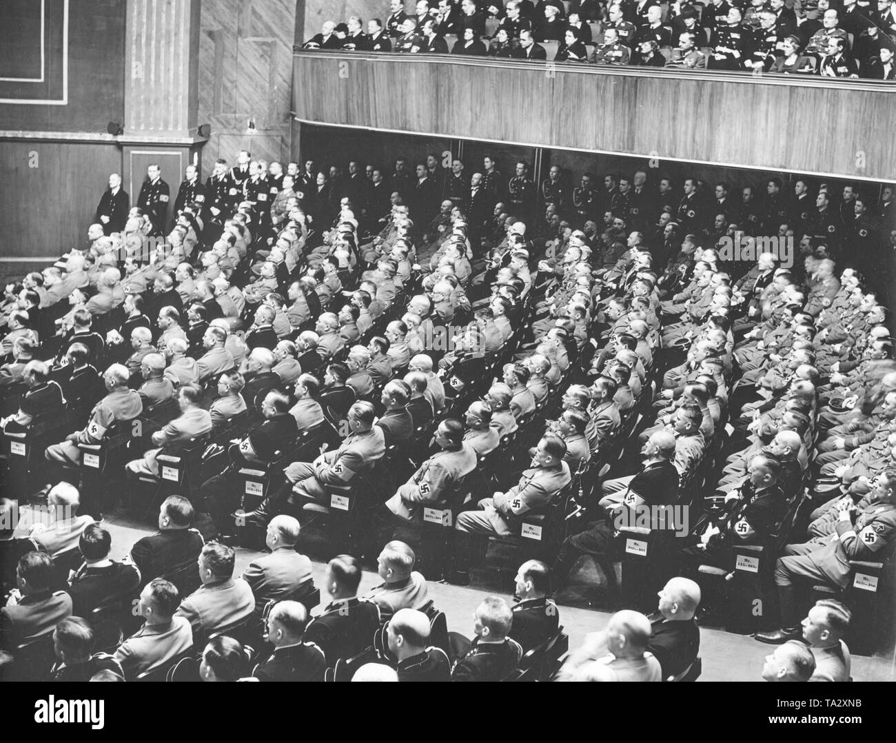 View of the plenum of NSDAP deputies during Adolf Hitler's speech on the 6th anniversary of the seizure of power in front of the Reichstag in the Kroll Opera House in Berlin. Stock Photo