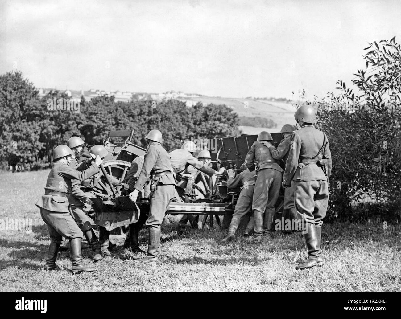 Czech soldiers are positioning a cannon in the suburb of Motol in Prague. After the termination of negotiations between British Prime Minister Chamberlain and Adolf Hitler, the Czech army was mobilized. Stock Photo
