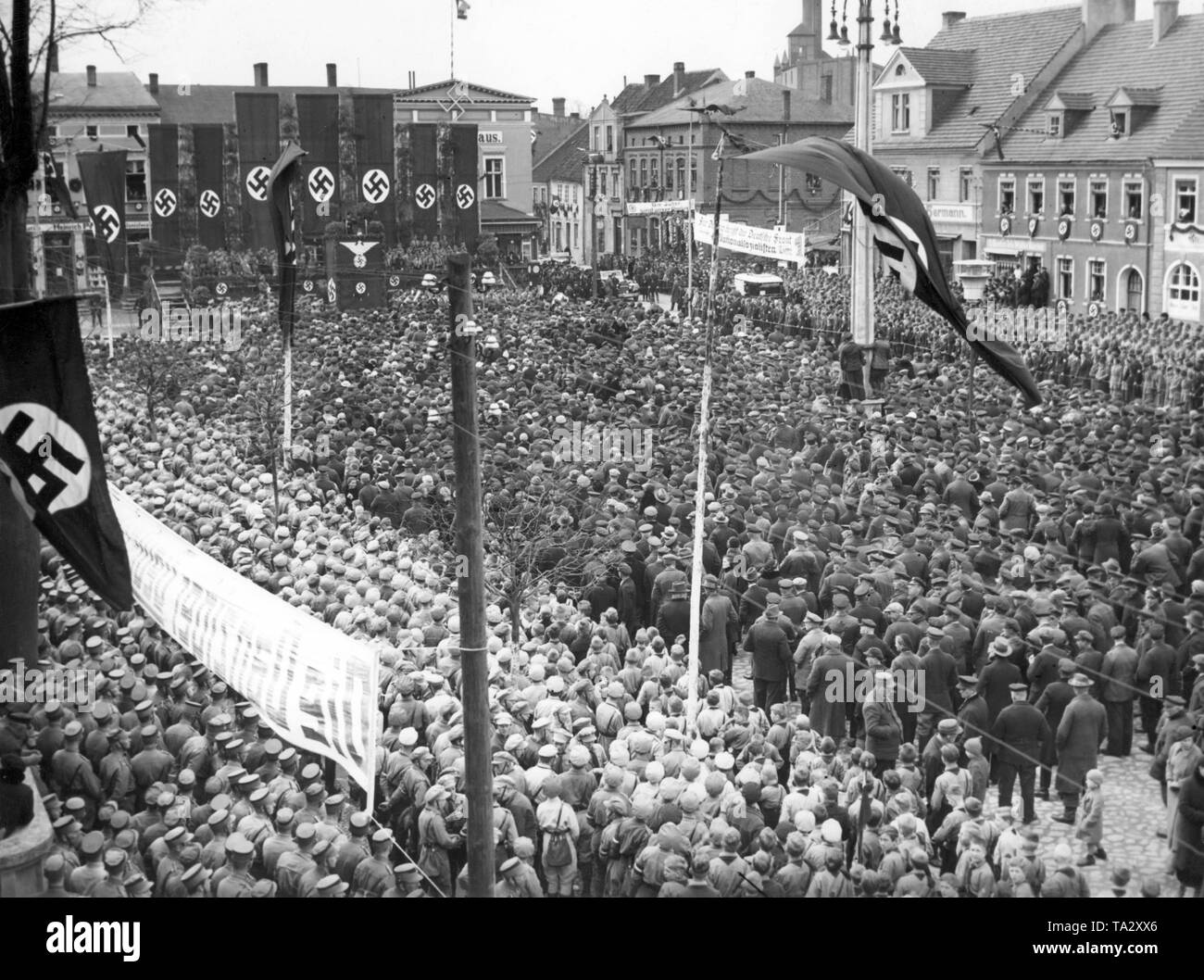 Propaganda Minister Joseph Goebbels is giving a speech after the electoral victory of the NSDAP in the parliamentary election of Gdansk at a Nazi mass rally in Neuteich. Although the NSDAP had obtained a majority, it did not obtain a two-thirds majority, so Gdansk was not yet brought into line. On the banners, Nazi propaganda slogans such as 'The Jews are our misfortune' and 'For Gdansk the German Front means National Socialist List 1'. Stock Photo