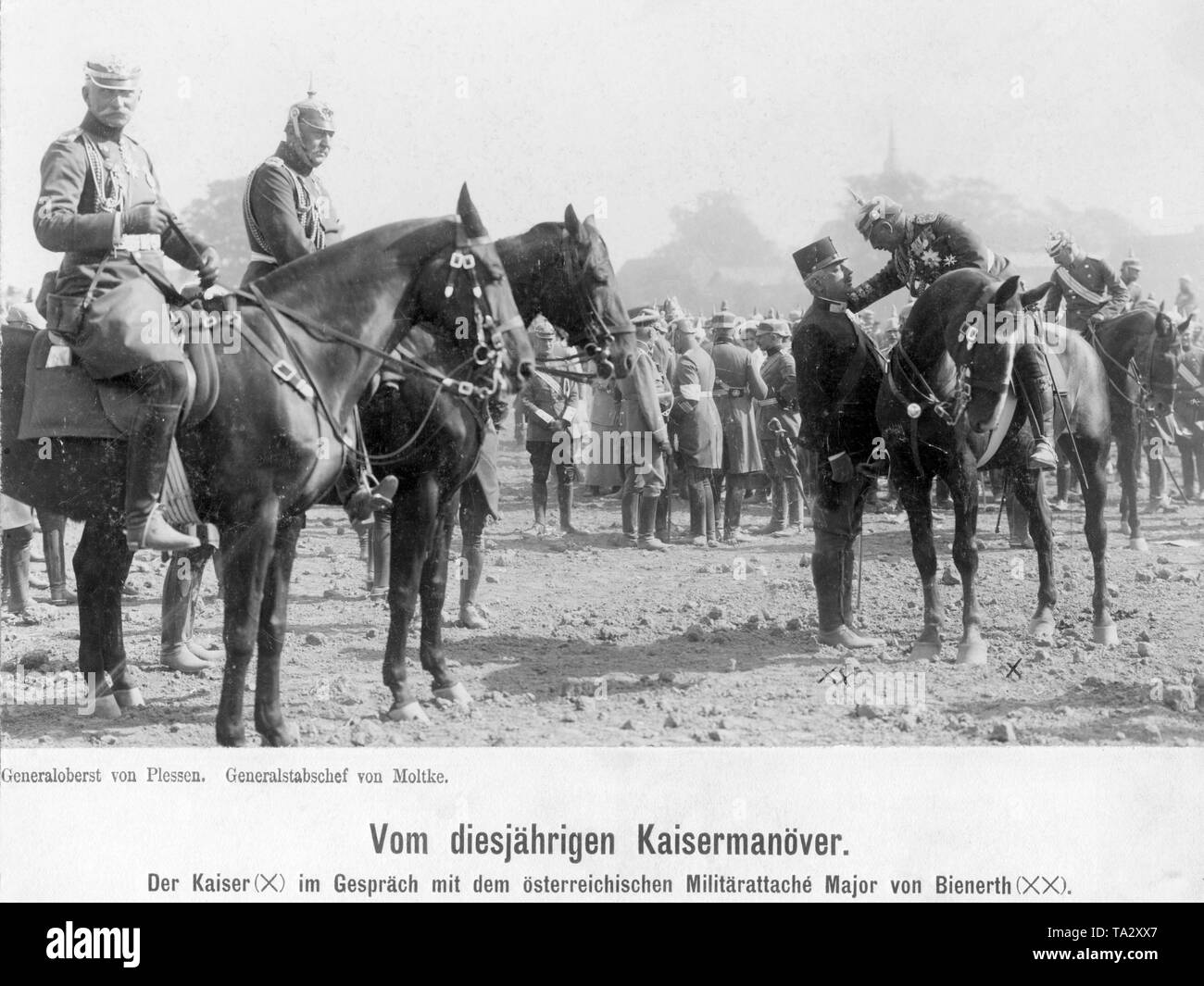 Emperor William II, 1910 (X, on the left on horseback in general field marshal uniform) leans forward to talk with the Austrian military attache Freiherr von Bienerth (XX, standing next to him). On the left next to him on horseback: Colonel-General Hans Georg von Plessen (left) and Great General Staff Helmut Johannes Ludwig von Moltke. In the background soldiers and maneuver observers. Stock Photo